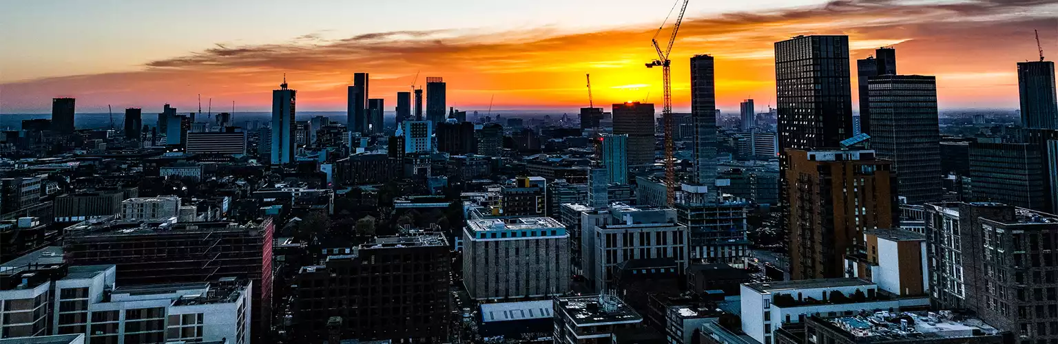 A picture of the Manchester skyline during a sunset