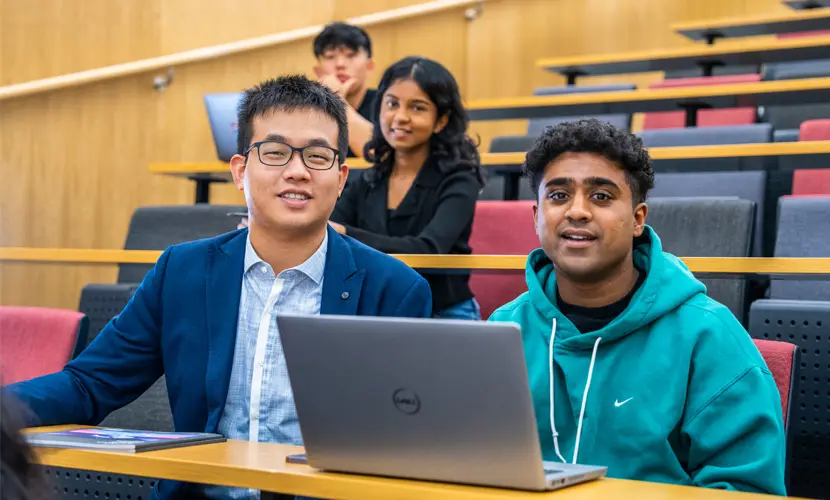 Four students in a lecture theatre.