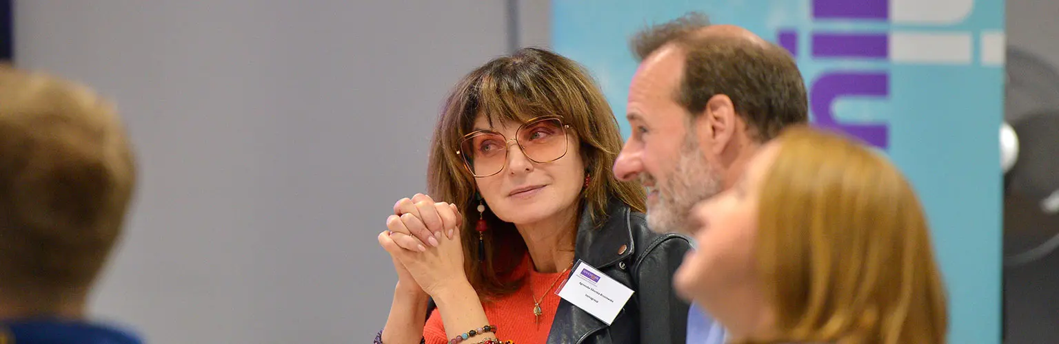 A group of senior professionals sitting together in a classroom environment