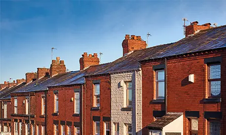 A row of terraced houses on a street in Northwest England.
