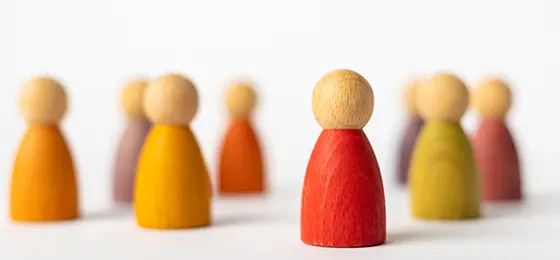 Eight wooden figures representing people.