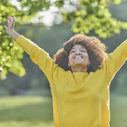 A woman enjoying a warm summers evening outside in a park discovery block