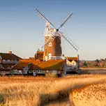 Image shows a windmill set among marshes in Norfolk