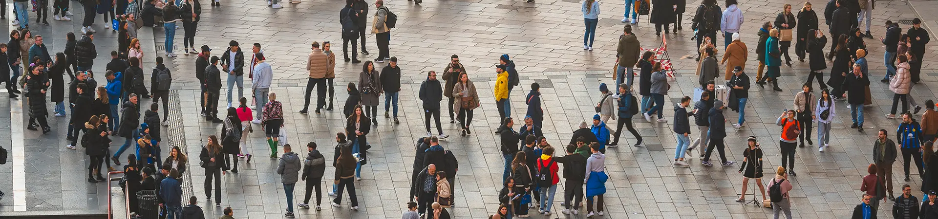 Busy pedestrian crowd in a city square.