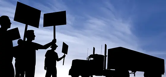 Silhouettes of workers on strike.