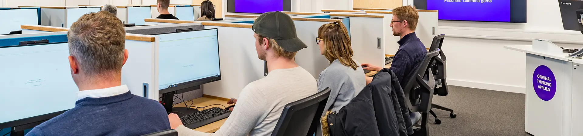 Four researchers working on computers.