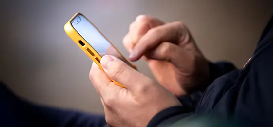 A person typing on a smartphone.