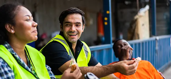 Cheerful dock workers chatting while on their break from work.