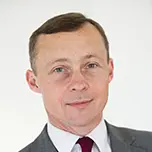 A professional headshot of Kieran Walshe.