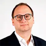 A professional headshot of Nils Gutacker.