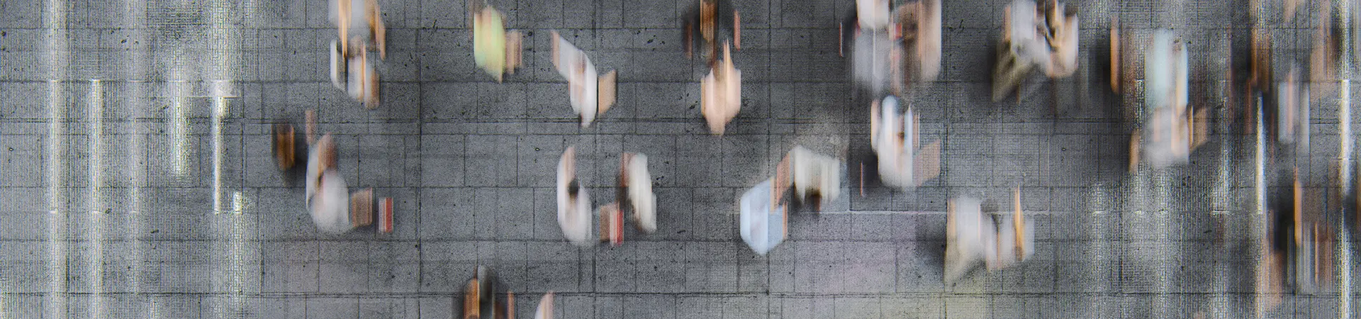 Businessman standing in the fast moving crowds of commuters