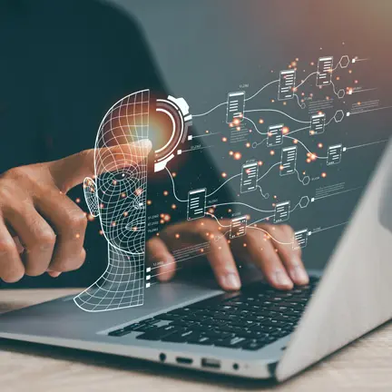 A person using a laptop to draw a graphic brain.