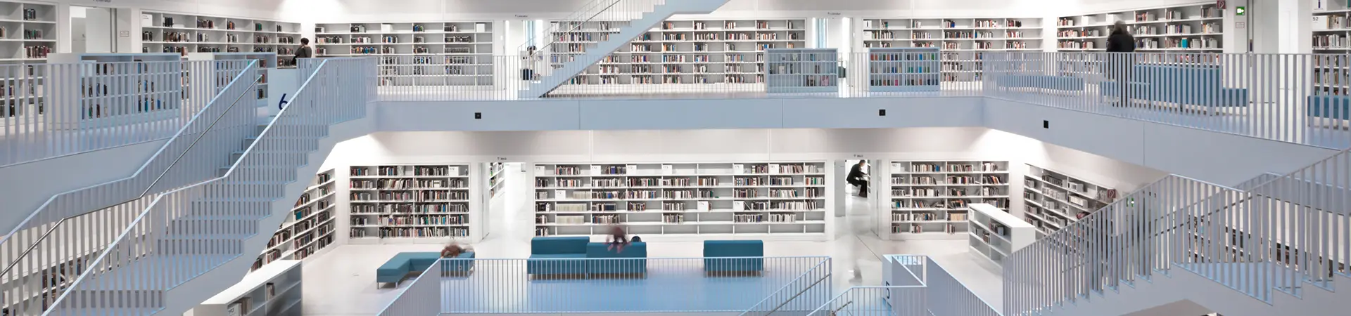 Public library with blurred people walking around and looking at books