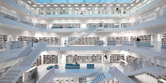 Public library with blurred people walking around and looking at books