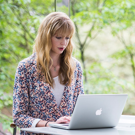 a girl studying on her laptop