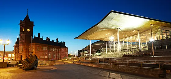 Night shot of the Senedd and Pierhead building in Wales.