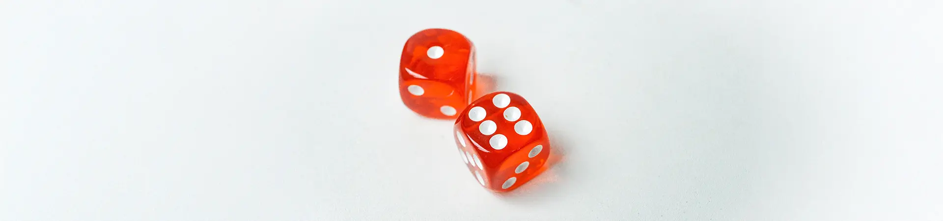 Two red dice, one displaying a one and the other a six.