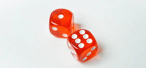 Two red dice, one displaying a one and the other a six.
