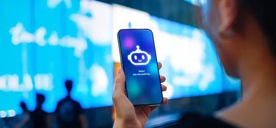 A person holding a smartphone with an AI chatbot on screen.