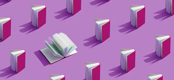 Open book surrounded by closed books with purple covers on a purple background.