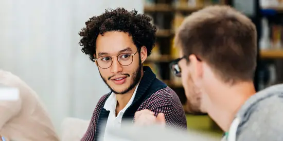 Two men having a discussion in their workplace