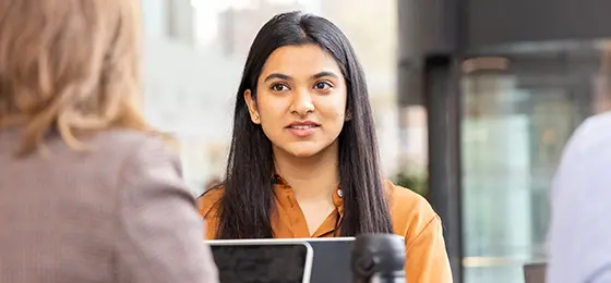 A female and male student talking to each other at AMBS.