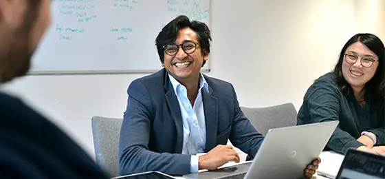 Male MBA student smiling during a workshop.