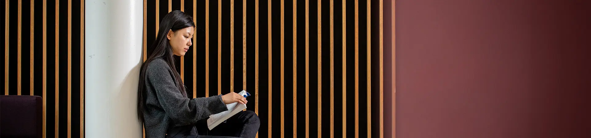 A female student reading a book.