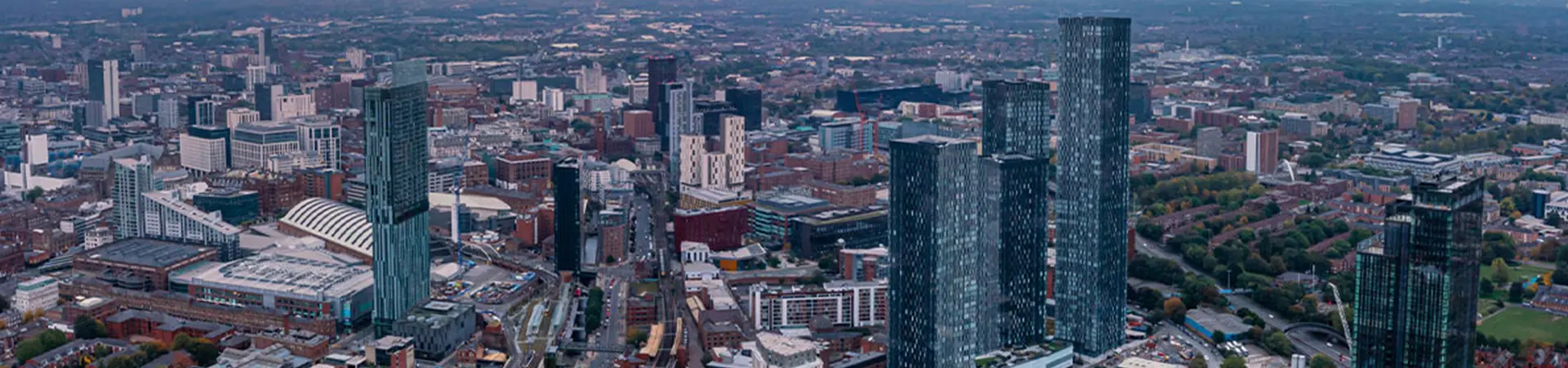 Aerial view of Manchester city centre at sunset.